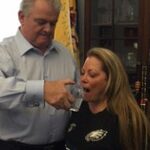 Rep. Bob Brady in his office sharing a glass of water previously touched by Pope Francis with his wife, Debra Brady.