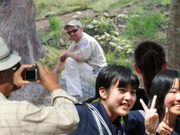 Large Crowds Observe Giant White Panda Zookeeper